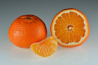 Whole and halved mandarin fruit with a peeled segment