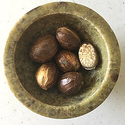 Whole and halved nutmeg in shells